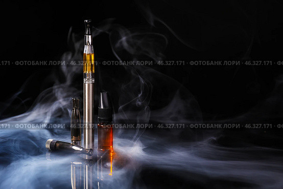 Electronic cigarette with oil on dark background with fume. Стоковое фото, фотограф Pixel_shot / Фотобанк Лори