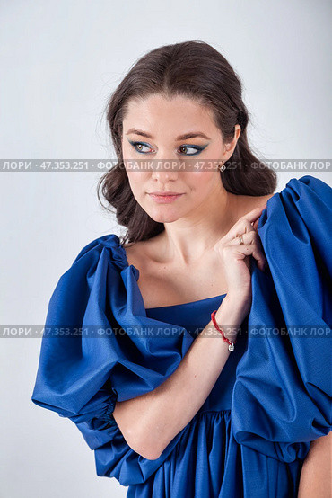 Elegant Portrait of a Woman in Striking Blue Attire, Showcasing Her Style in a Studio Setting. Стоковое фото, фотограф Aleksandr Golubev / Фотобанк Лори