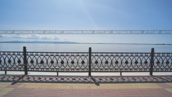Embankment with a black fence. View of the river in motion. Стоковое видео, видеограф Mikhail Davidovich / Фотобанк Лори