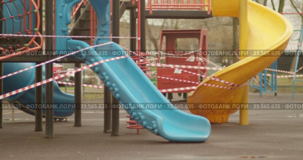 Empty playgrounds covered with a protective tape during quarantine of coronavirus, covid-19 virus. Стоковое видео, видеограф Aleksandr Lutcenko / Фотобанк Лори