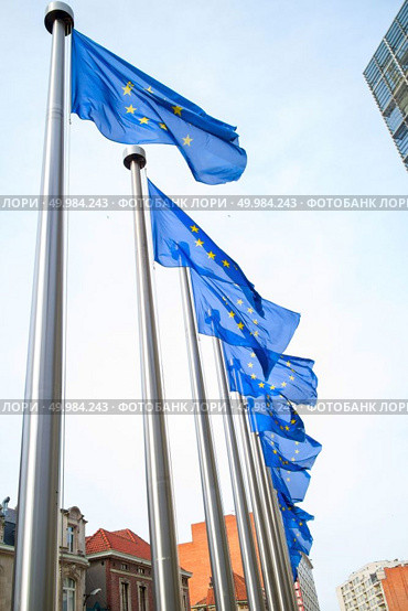 European flags in front of the Berlaymont building in Brussels.. Flags in front of the EU Commission building. Стоковое фото, агентство Ingram Publishing / Фотобанк Лори