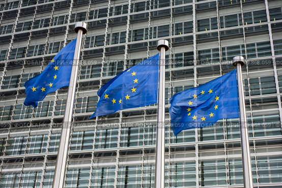 European Union flags in front of the Berlaymont building (European commission) in Brussels, Belgium. Стоковое фото, агентство Ingram Publishing / Фотобанк Лори