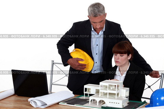 Experienced architect giving a young colleague advice. Стоковое фото, фотограф Phovoir Images / Фотобанк Лори