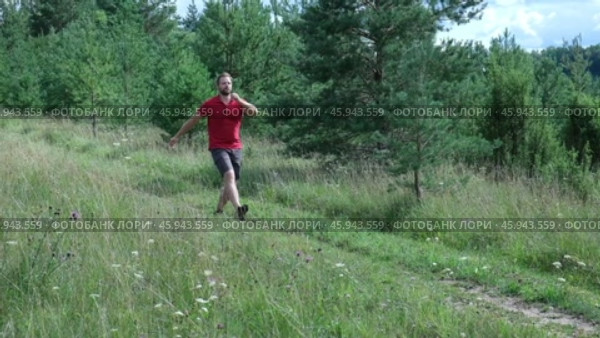 Exploring Nature a Hiker with backpack Strolling Through a Beautiful Field Beneath Vast Blue Sky. Tourist man traverses a scenic field, clear blue sky. Adventure and exploration concept. One person. Стоковое видео, видеограф Марина Демидюк / Фотобанк Лори