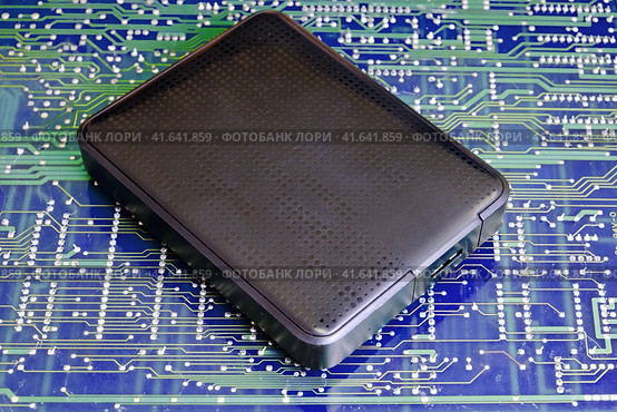 External portable hard drive in blue background. Стоковое фото, фотограф Андрей Журавлев / Фотобанк Лори
