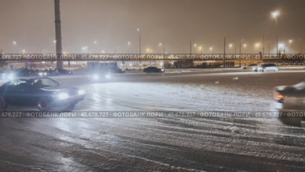 Fans of winter drift in the parking lot covered with ice near the Mega Belaya Dacha shopping center practice their skills in passing the ice turn. Редакционное видео, видеограф Ярославский Максим / Фотобанк Лори