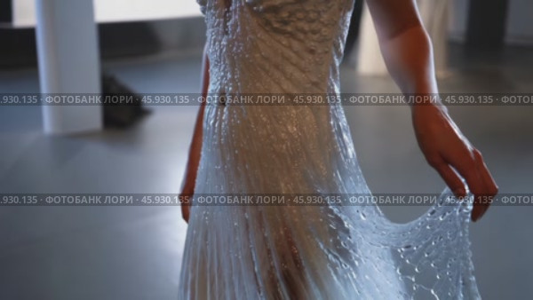 Fashion designer showing innovative waterproof wedding dress. Стоковое видео, видеограф Данил Руденко / Фотобанк Лори