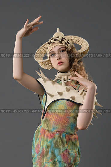 Fashion model showcases unique, avant-garde outfit with striking accessories. Стоковое фото, фотограф Гурьянов Андрей / Фотобанк Лори