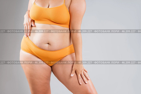 Fat woman in orange underwear on gray background, obesity and cellulite, overweight female body, weight loss concept. Стоковое фото, фотограф Станислав Тарко / Фотобанк Лори