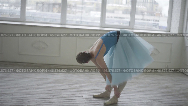 Female ballerina having a rest after performance or rehearsal. Стоковое фото, фотограф David Kashakhi / Фотобанк Лори