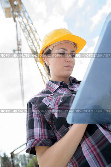 female contractor at a work site using an ipadtablet. Стоковое фото, агентство Ingram Publishing / Фотобанк Лори