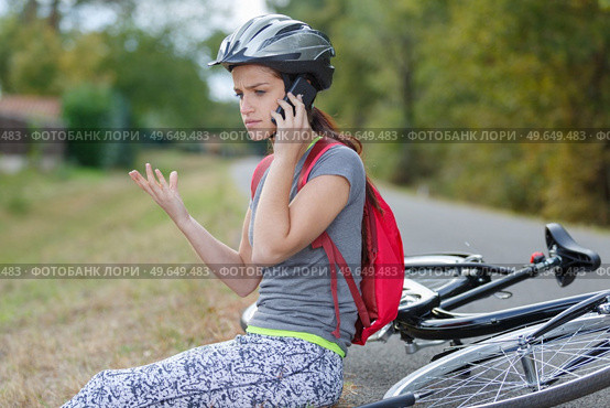 female on the floor after bike accident. Стоковое фото, агентство Ingram Publishing / Фотобанк Лори