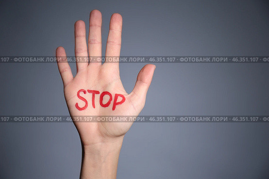 Female palm with word STOP on grey background. Corruption concept. Стоковое фото, фотограф Pixel_shot / Фотобанк Лори