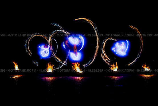 fiery pieces of a fire show against a dark sky and thunderstorms. Стоковое фото, агентство Ingram Publishing / Фотобанк Лори