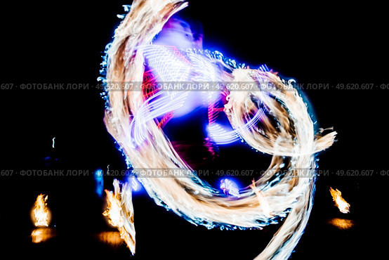 fiery pieces of a fire show against a dark sky and thunderstorms. Стоковое фото, агентство Ingram Publishing / Фотобанк Лори