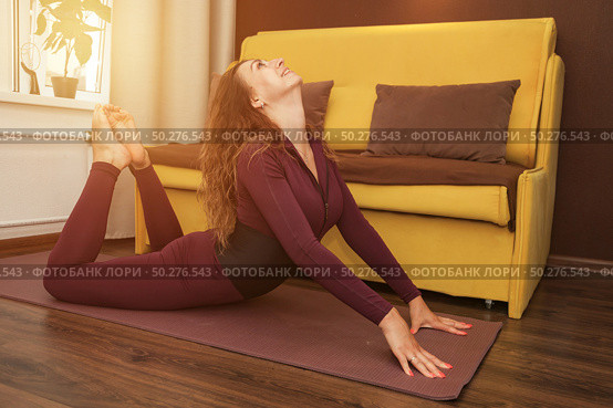 Finding Flexibility Friday With a Beautiful Backbend in Her Living Room. Стоковое фото, фотограф Aleksandr Golubev / Фотобанк Лори