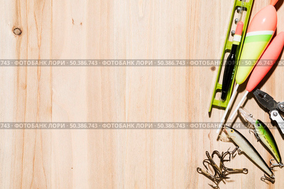 fish bobber hook fishing lure fishing line plier wooden desk. Стоковое фото, агентство Ingram Publishing / Фотобанк Лори