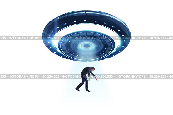 Flying saucer abducting young businessman. Стоковое фото, фотограф Elnur / Фотобанк Лори