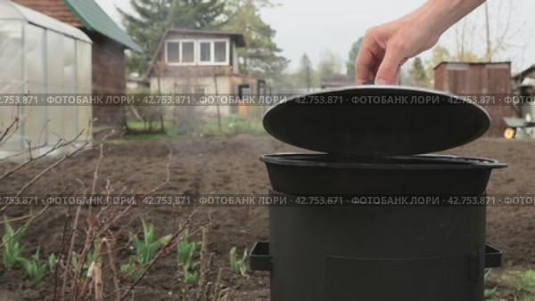Food is prepared in a cauldron outdoors in the courtyard. Boiling water vapor. Slow motion. The man opens the lid of the pan. Two videos. Стоковое видео, видеограф Дмитрий Кобзев / Фотобанк Лори