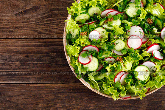 Fresh vegan vegetable salad of radish, cucumbers, lettuce, dill and green onion, healthy vegetarian food. Стоковое фото, агентство Ingram Publishing / Фотобанк Лори