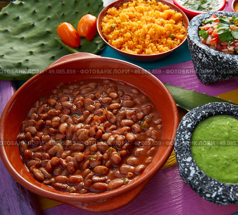 Frijoles mexican beans with rice and sauces nopal and pico de gallo. Стоковое фото, агентство Ingram Publishing / Фотобанк Лори