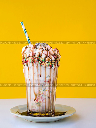 front view delicious milkshake with yellow background. High resolution photo. front view delicious milkshake with yellow background. High quality photo. Стоковое фото, агентство Ingram Publishing / Фотобанк Лори