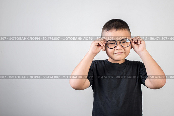 Funny boy genius wearing glasses in studio shot. Стоковое фото, агентство Ingram Publishing / Фотобанк Лори