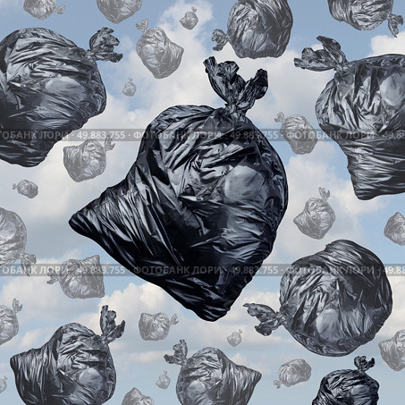 Garbage concept as black trash bags with an unpleasant smell falling from the sky as a background of environmental damage issues and waste management problems. Стоковое фото, агентство Ingram Publishing / Фотобанк Лори
