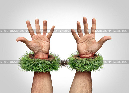 Garden work concept and being a slave to your yard chores as mowing grass and backyard landscaping job as trapped hands with handcuffs or hand cuffs shaped as green rolls of sod or turf and roots. . Стоковое фото, агентство Ingram Publishing / Фотобанк Лори