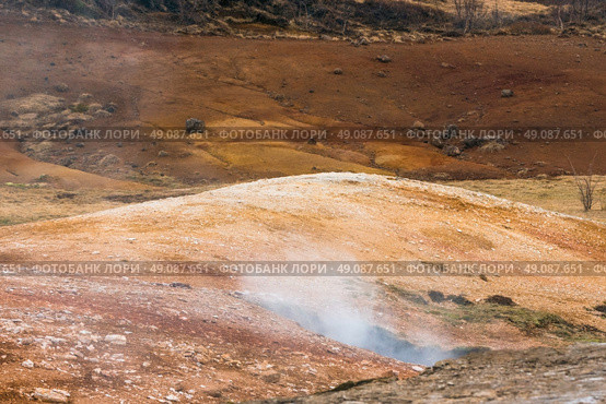 Geothermal activity in icelandic nature with steam coming up from the ground. Стоковое фото, агентство Ingram Publishing / Фотобанк Лори