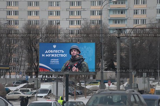 Герой СВО старший матрос Арсений Морозов на банере в Москве (2024 год). Редакционное фото, фотограф Дмитрий Неумоин / Фотобанк Лори
