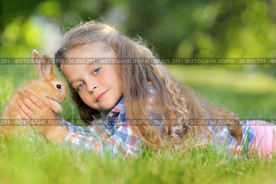 Girl with a cute little rabbit, outdoor, summer day. Стоковое фото, фотограф Чирцова Наталья / Фотобанк Лори