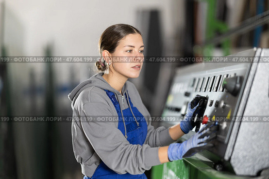 Girl workshop employee switches toggle switch on control panel. Стоковое фото, фотограф Яков Филимонов / Фотобанк Лори