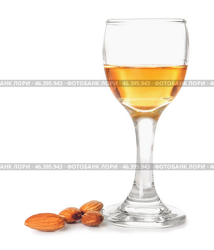 Glass of almond liquor and nuts on white background. Стоковое фото, фотограф Pixel_shot / Фотобанк Лори
