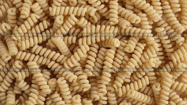 Gluten Free Cornmeal Pasta Wallpaper. Spiral Raw Macaroni from Corn and Rice flour rotating on Turntable. Close Up Top View. Uncooked Pasta Spinning. Full Frame. Food Background. Fusilli Bucati Corti. Стоковое видео, видеограф Марина Демидюк / Фотобанк Лори