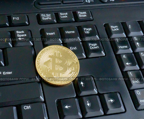 Golden bitcoin on black keyboard closeup. Стоковое фото, фотограф Курганов Александр / Фотобанк Лори