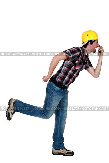 Goofy tradesman holding an object. Стоковое фото, агентство Ingram Publishing / Фотобанк Лори