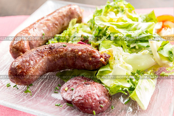 grilled german sausages serve with fresh vegetable. Стоковое фото, агентство Ingram Publishing / Фотобанк Лори
