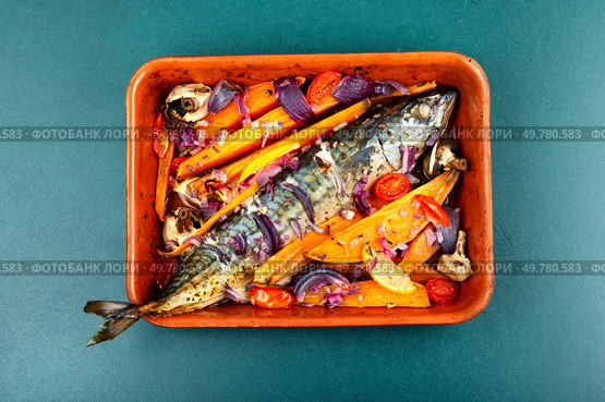 Grilled mackerel with vegetables, sauce and sweet potato. Tasty healthy dish of fish. Top view.. Mackerel with roasted vegetables in roasting pan. Стоковое фото, агентство Ingram Publishing / Фотобанк Лори