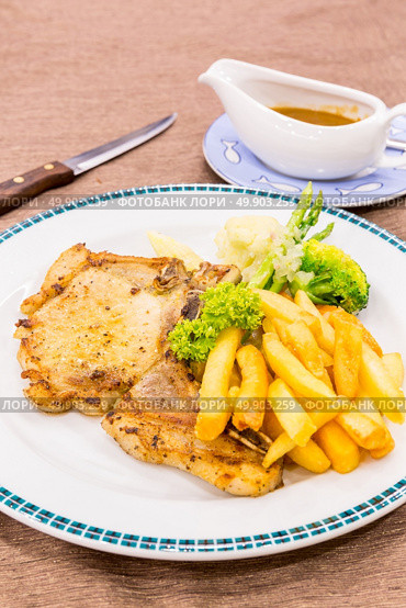 grilled pork chops with french fries. Стоковое фото, агентство Ingram Publishing / Фотобанк Лори