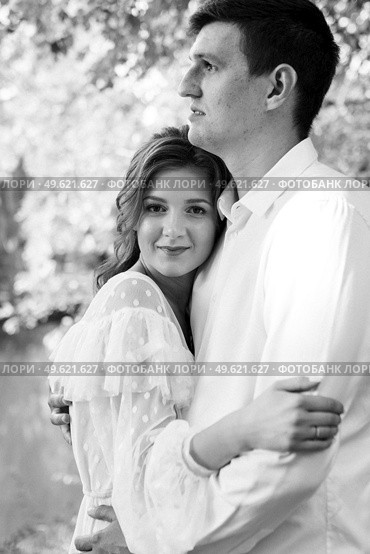 guy and a girl walk along the paths of a forest park between tall trees. Стоковое фото, агентство Ingram Publishing / Фотобанк Лори
