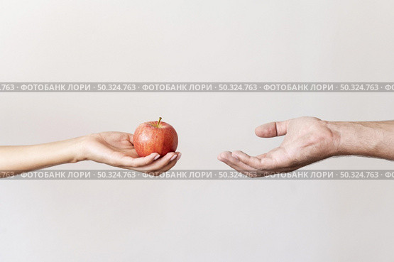 hand giving apple fruit needy person. Стоковое фото, агентство Ingram Publishing / Фотобанк Лори