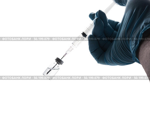 Hand in a blue glove holding syringe isolated on white background. Стоковое фото, агентство Ingram Publishing / Фотобанк Лори