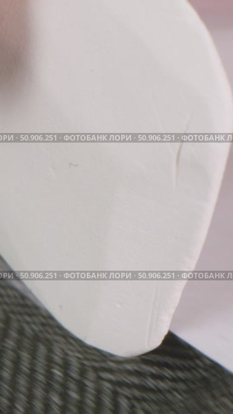 Hand of woman with delicate beige manicure carefully tracing pattern template on fabric with chalk, concept of preparation process for sewing clothes in garment factory. Стоковое видео, видеограф Дмитрий Нечаев / Фотобанк Лори