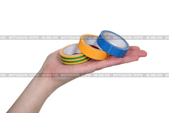 hand showing rolls of adhesive tape. Стоковое фото, агентство Ingram Publishing / Фотобанк Лори