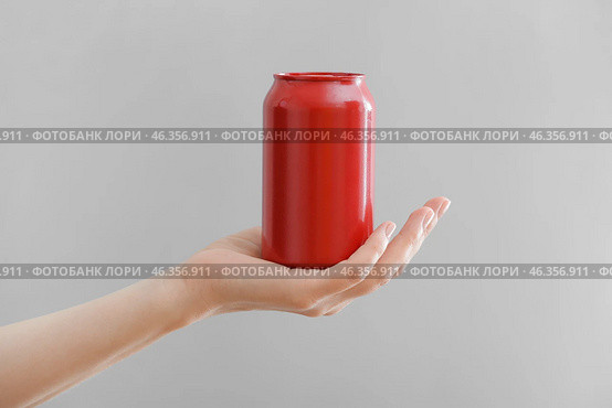 Hand with can of soda on grey background. Стоковое фото, фотограф Pixel_shot / Фотобанк Лори