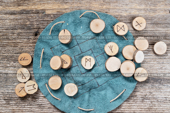 Handmade runes for fortunetelling over leather chart. Handmade runes for fortunetelling. Стоковое фото, агентство Ingram Publishing / Фотобанк Лори