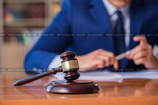 Handsome judge with gavel sitting in courtroom. Стоковое фото, фотограф Elnur / Фотобанк Лори
