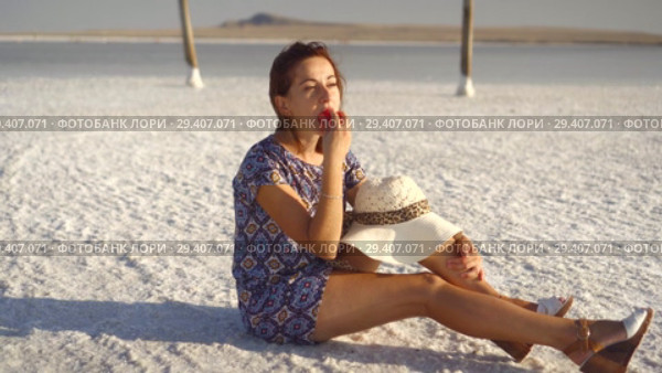 happy smiling girl enjoying the sunset, eating watermelon, sit on salt, pillars. Стоковое видео, видеограф Ирина Мойсеева / Фотобанк Лори