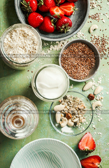 Healthy vegan breakfast ingredients, coconut yogurt, oat-flakes, nuts, linseed and berries , top view. Стоковое фото, агентство Ingram Publishing / Фотобанк Лори